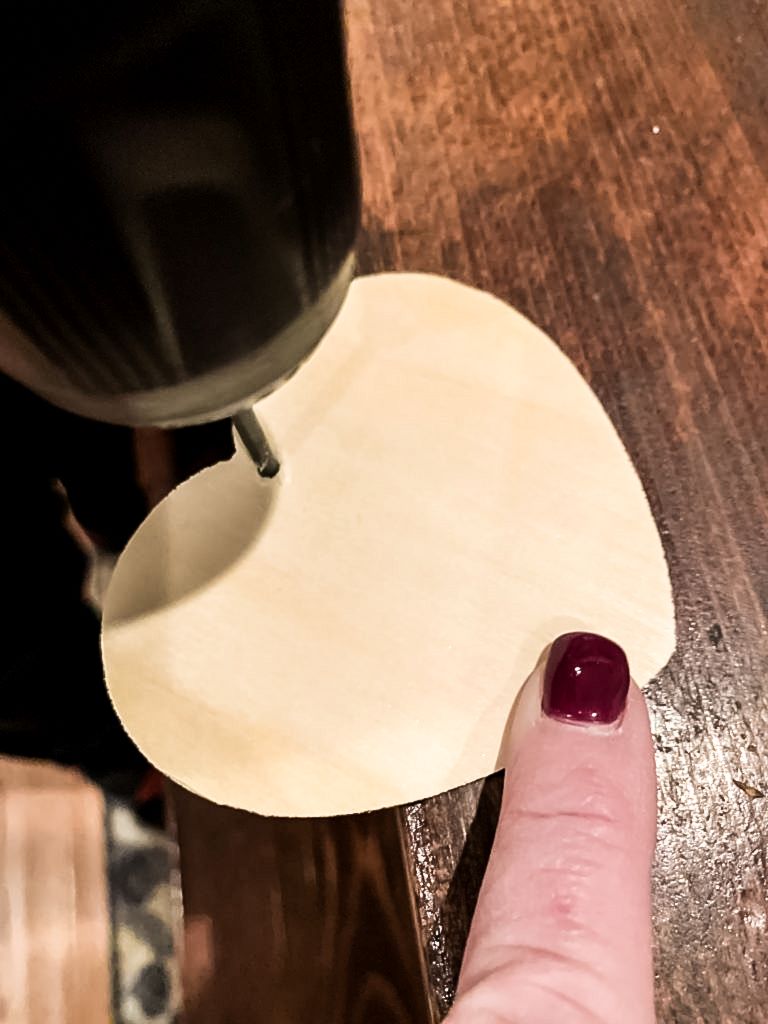 Drilling a hole in a 3 inch wooden heart. 