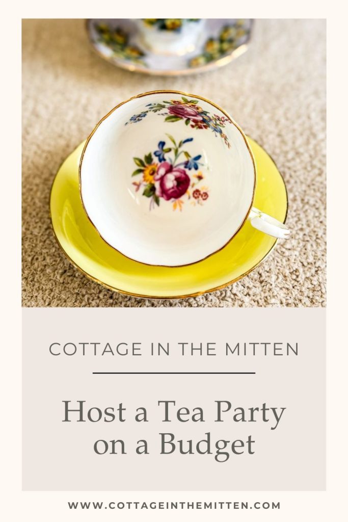 A vintage porcelain teacup with a colorful floral pattern inside sits on a bright yellow saucer. Below the image, text reads: "Cottage in the Mitten - Host a Tea Party on a Budget - www.cottageinthemitten.com".