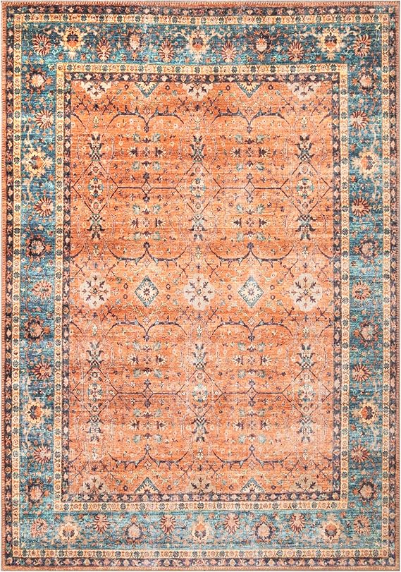 Vintage-inspired area rug with a tribal pattern in shades of orange, blue, and red.