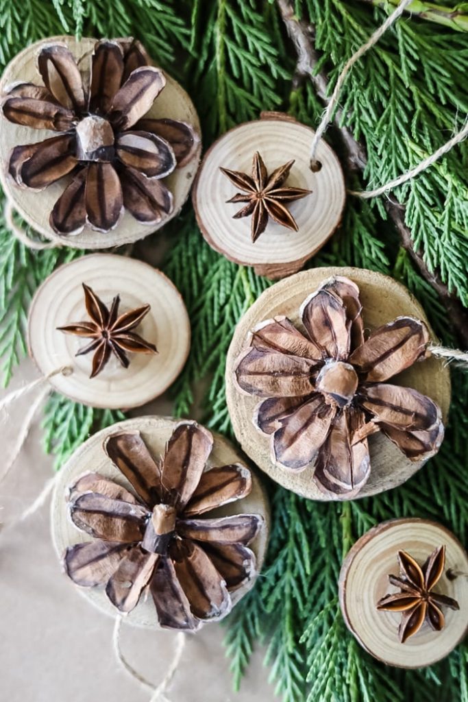 A pinecone and wood ornament hung with jute twine. 