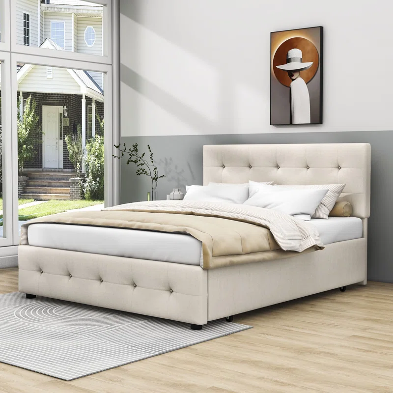 Queen Size upholstered platform bed with a beige tufted fabric headboard, featuring a hidden twin  size trundle and two pull-out storage drawers on a light wood floor.