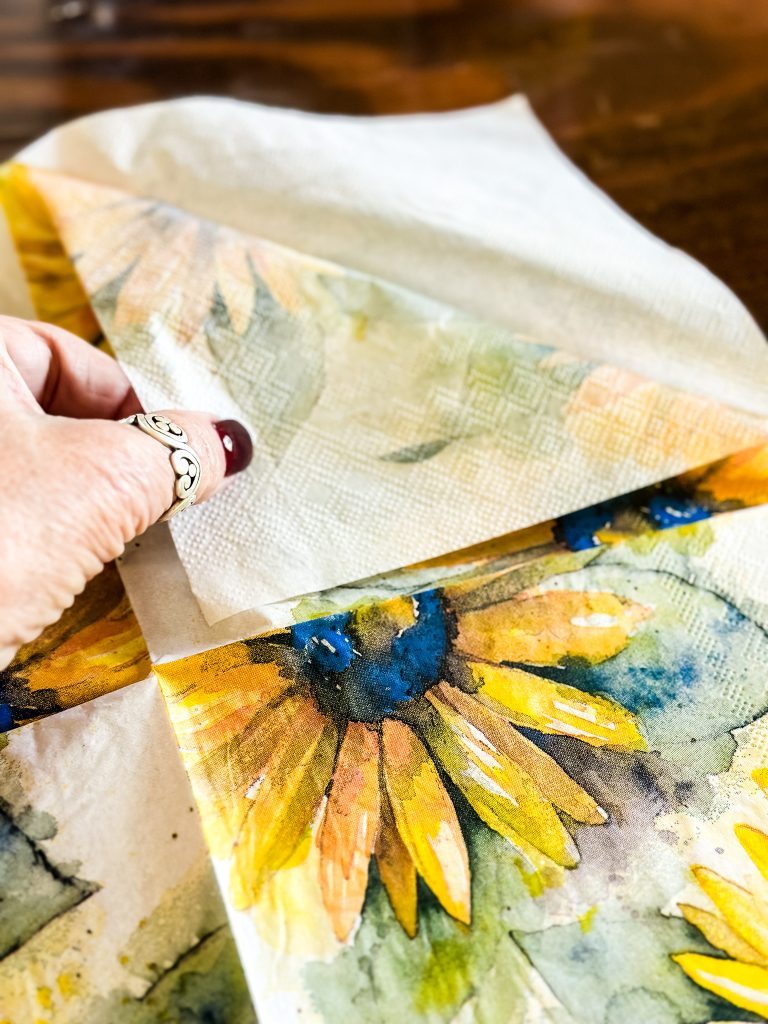 Separating the layers of a sunflower napkin. 