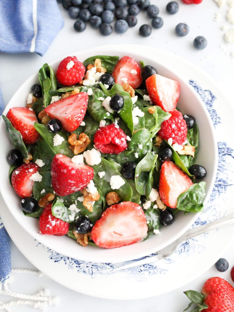 A fresh spinach strawberry and blueberry salad. 