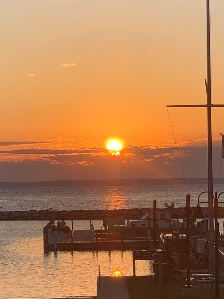 Stunning orange sunset over Lake Michigan viewed from the Leland Fishtown marina on the Leelanau Peninsula.