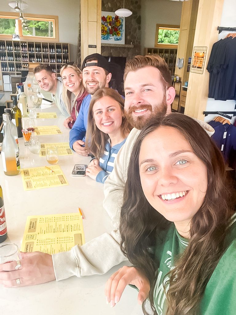 Group of friends enjoying a wine tasting at a Michigan winery on the Leelanau Peninsula.