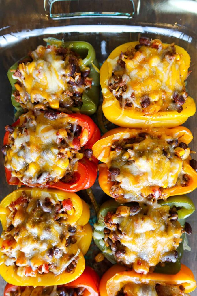 Homemade stuffed bell peppers with ground beef, black beans, corn, and melted cheddar cheese.