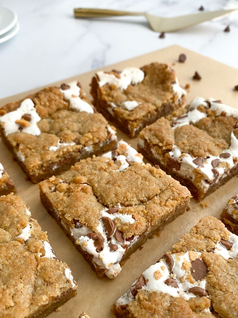 Freshly baked s'mores cookie bars layered with graham crackers, marshmallow creme, and melted chocolate chips.
