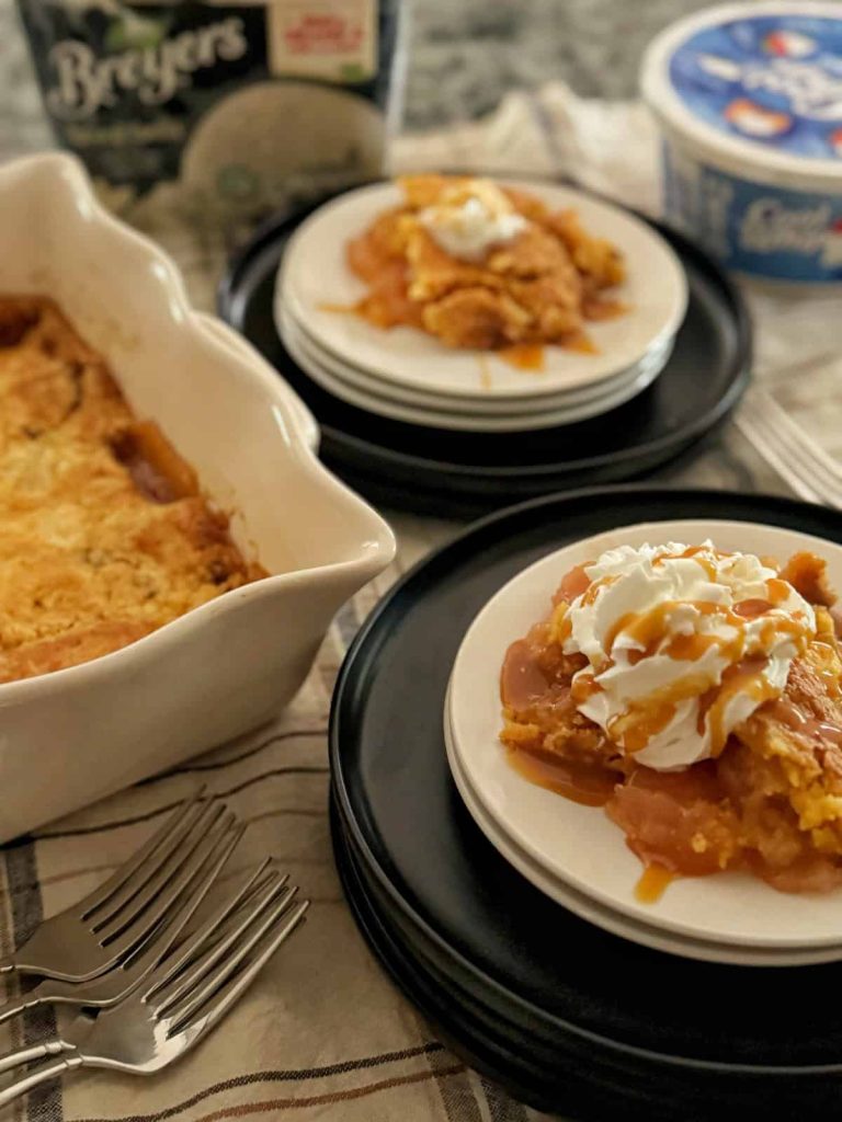 Warm apple dump cake with buttery cake topping and sliced baked apples in a casserole dish.