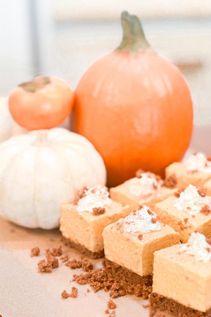 Creamy no-bake pumpkin cheesecake bars on a graham cracker crust with autumn spice toppings.
